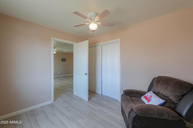 sitting room featuring ceiling fan and light wood-type flooring