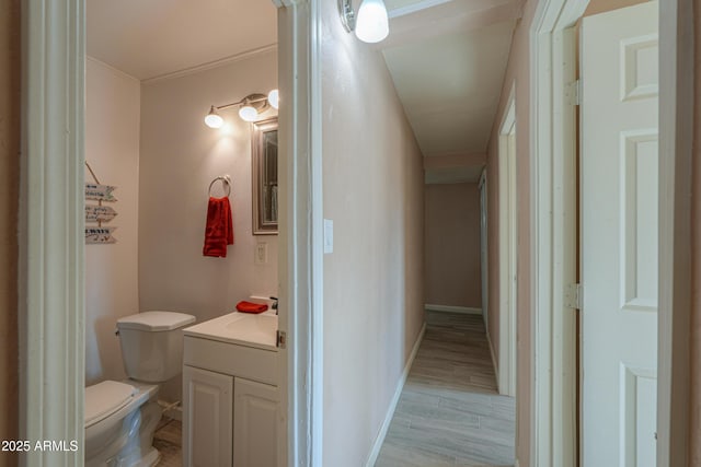 bathroom featuring hardwood / wood-style flooring, vanity, and toilet