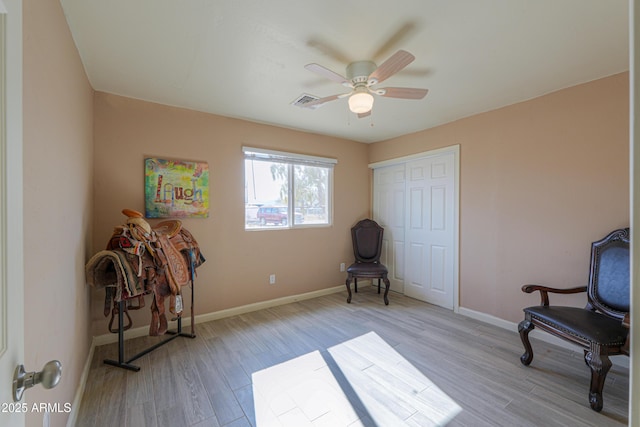 sitting room featuring light hardwood / wood-style flooring and ceiling fan