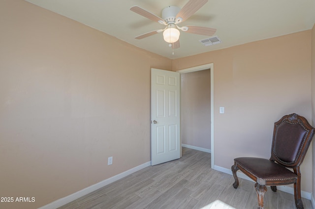 living area featuring ceiling fan and light hardwood / wood-style flooring