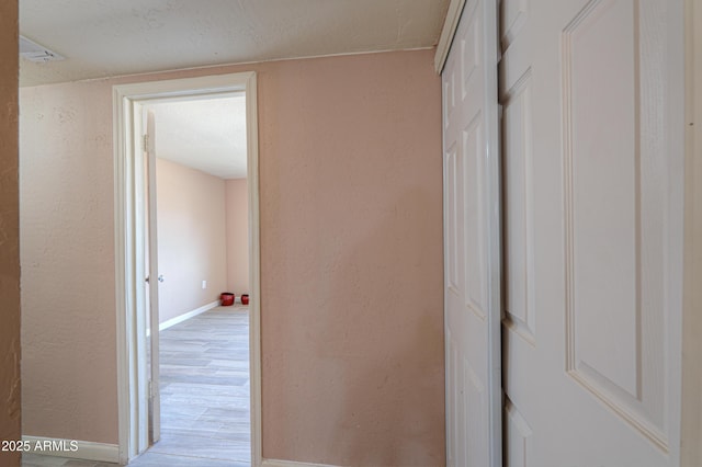 hall with light wood-type flooring