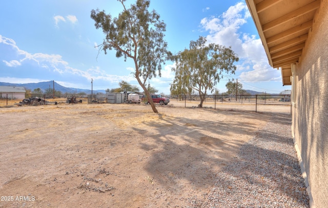 view of yard featuring a rural view and a mountain view