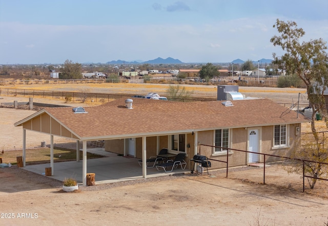 exterior space featuring a mountain view and a patio