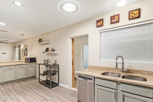 kitchen with appliances with stainless steel finishes, a sink, recessed lighting, light stone countertops, and baseboards