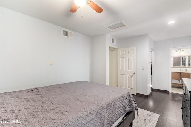 bedroom with attic access, dark wood-type flooring, ceiling fan, recessed lighting, and ensuite bathroom