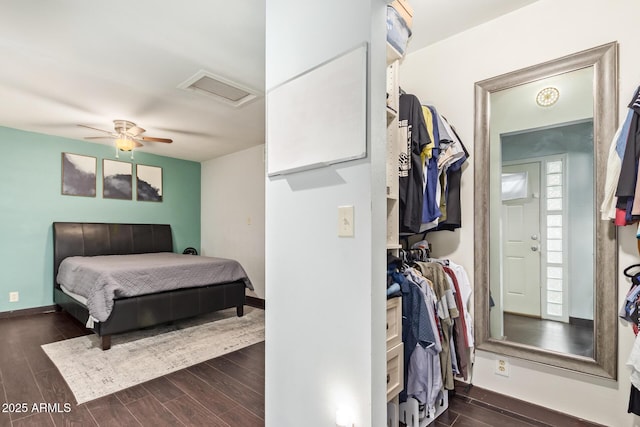 bedroom with attic access, dark wood-style floors, baseboards, and ceiling fan