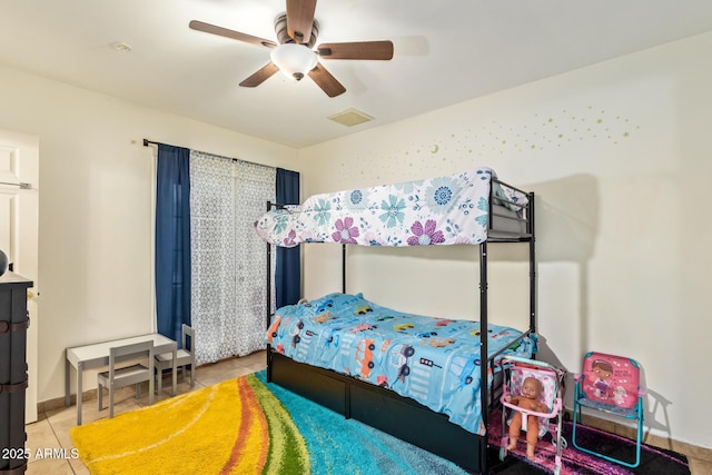 bedroom with tile patterned flooring and a ceiling fan