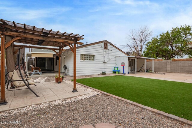 rear view of property with a patio, a pergola, and an outbuilding
