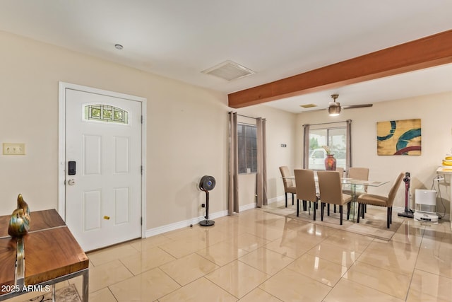 foyer with baseboards, beam ceiling, and light tile patterned floors