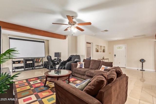 living area featuring ceiling fan, light tile patterned floors, beamed ceiling, and baseboards