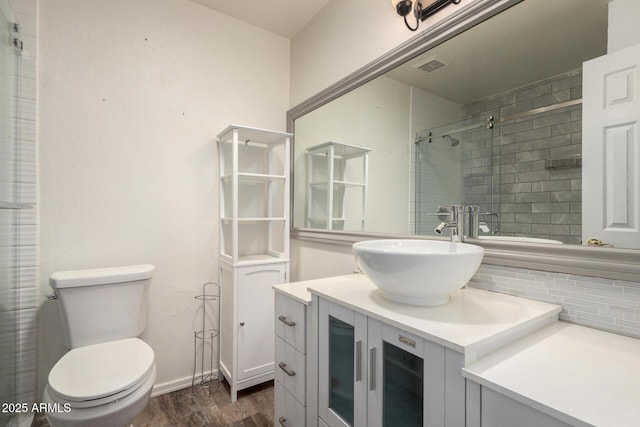 2059 E Brown Rd Unit 35, Mesa, AZ 85213 - bathroom featuring wood finished floors, vanity, decorative backsplash, and a tile shower