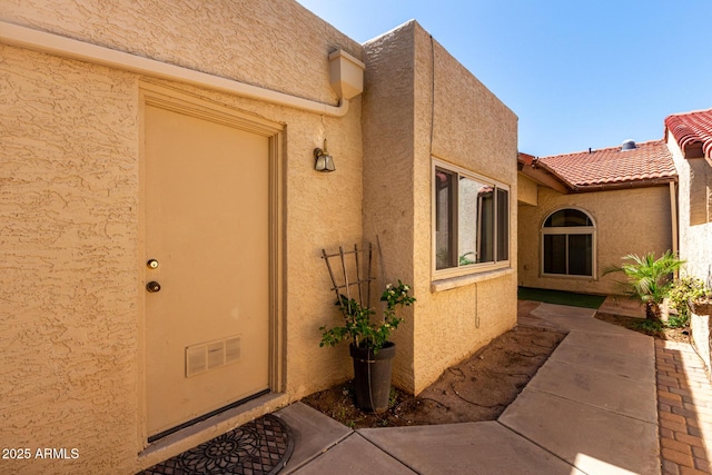 2059 E Brown Rd Unit 35, Mesa, AZ 85213 - view of exterior entry with stucco siding and a patio area