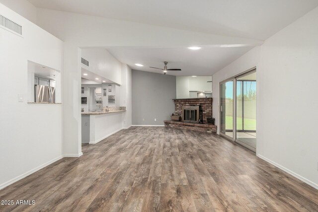 2059 E Brown Rd Unit 35, Mesa, AZ 85213 - unfurnished living room featuring a ceiling fan, wood finished floors, a fireplace, and recessed lighting