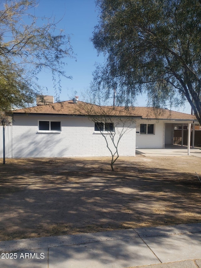 back of property featuring brick siding