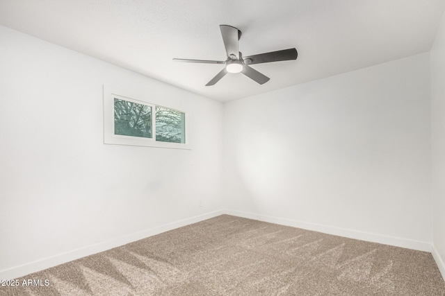 empty room with ceiling fan, carpet floors, and baseboards