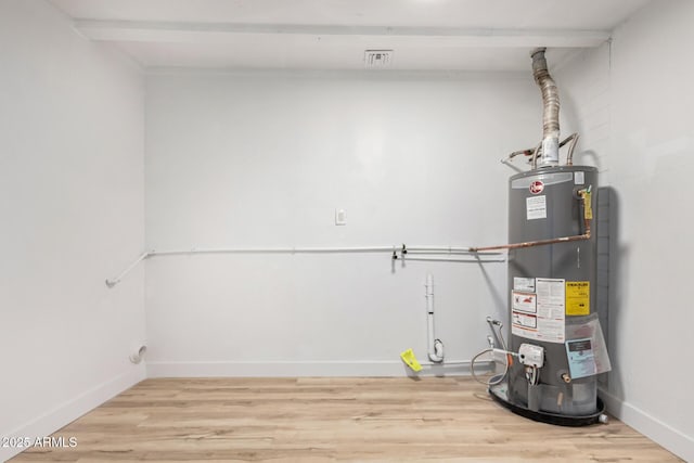 utility room featuring water heater