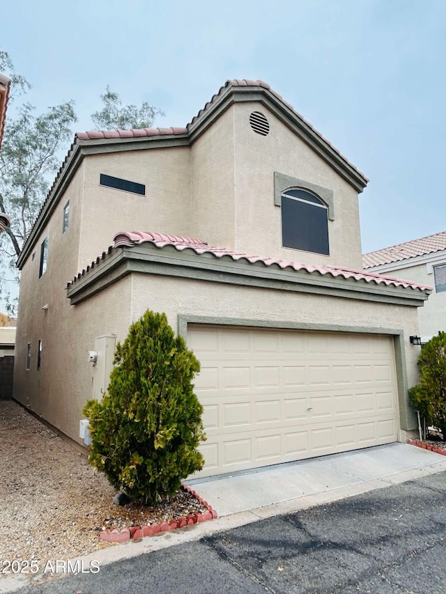 1750 W Union Hills Dr Unit 91, Phoenix, AZ 85027 - view of front of house featuring a garage, a tiled roof, and stucco siding