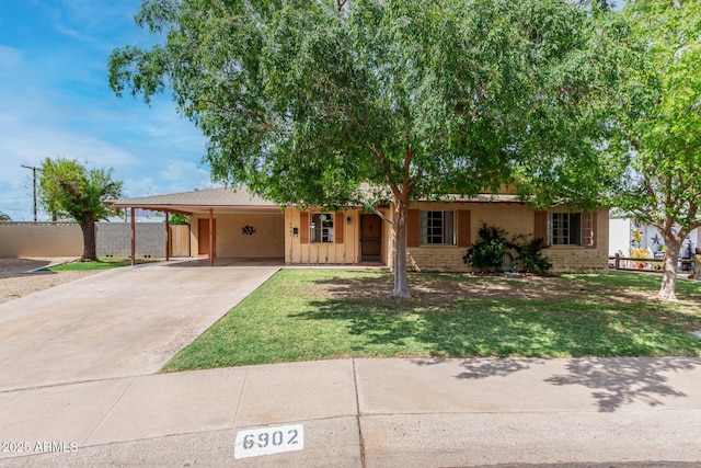 ranch-style home with a carport, concrete driveway, and brick siding