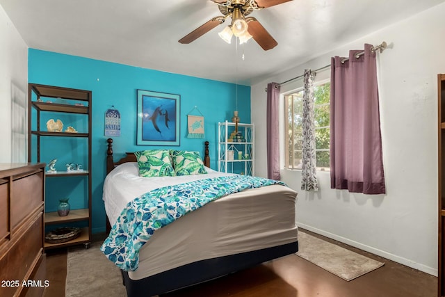 bedroom with baseboards, a ceiling fan, and finished concrete flooring