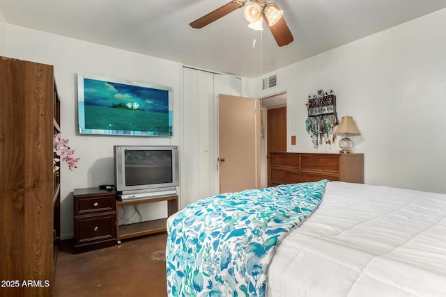 bedroom featuring concrete flooring, a closet, and a ceiling fan