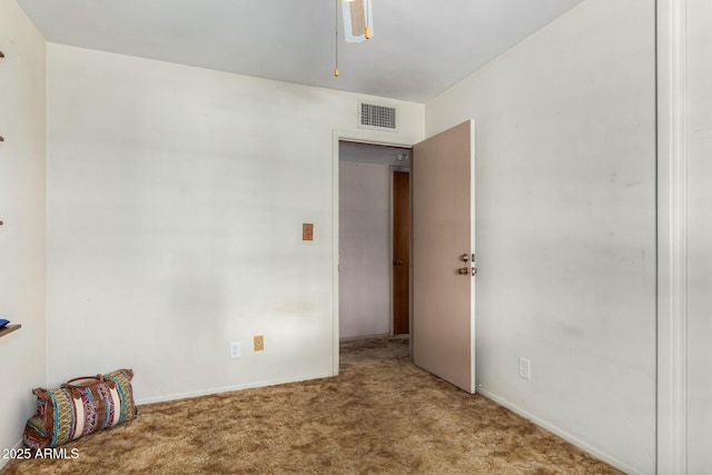 carpeted empty room featuring a ceiling fan and baseboards