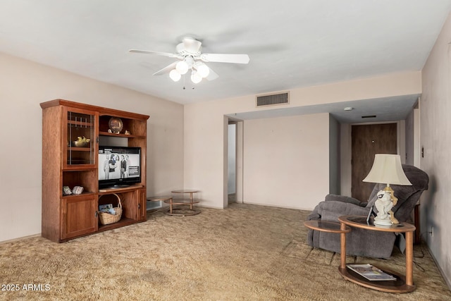 living area with ceiling fan and carpet flooring
