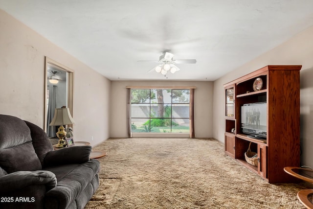 carpeted living room featuring a ceiling fan