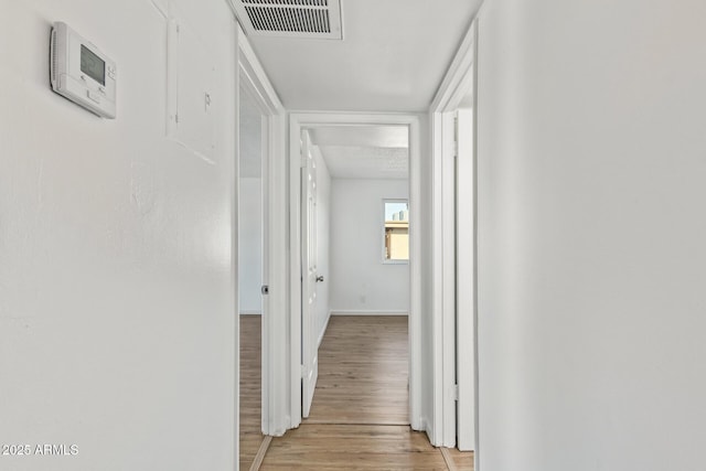 corridor with light hardwood / wood-style flooring