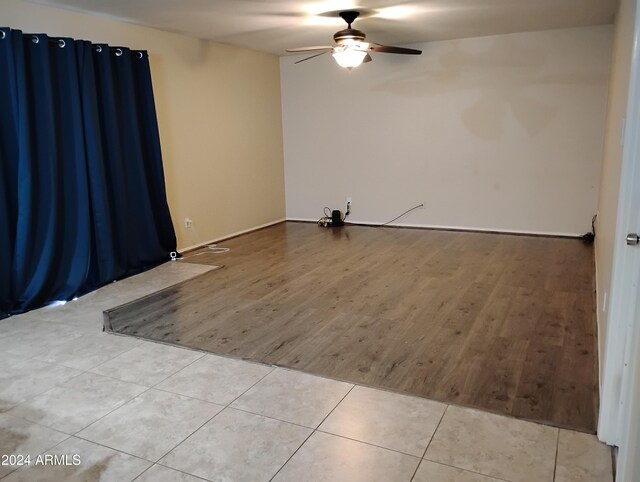 empty room featuring ceiling fan and light hardwood / wood-style floors