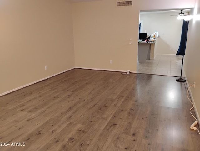 unfurnished room with ceiling fan and light hardwood / wood-style flooring