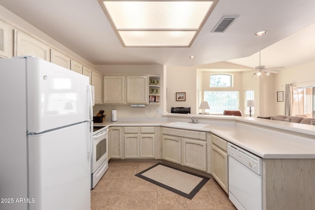 kitchen with white appliances, kitchen peninsula, sink, and light tile patterned floors