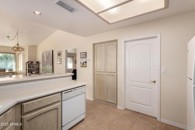 kitchen featuring decorative light fixtures, light brown cabinets, dishwasher, and light tile patterned flooring