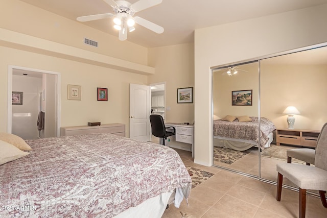 tiled bedroom featuring built in desk, a closet, and ceiling fan