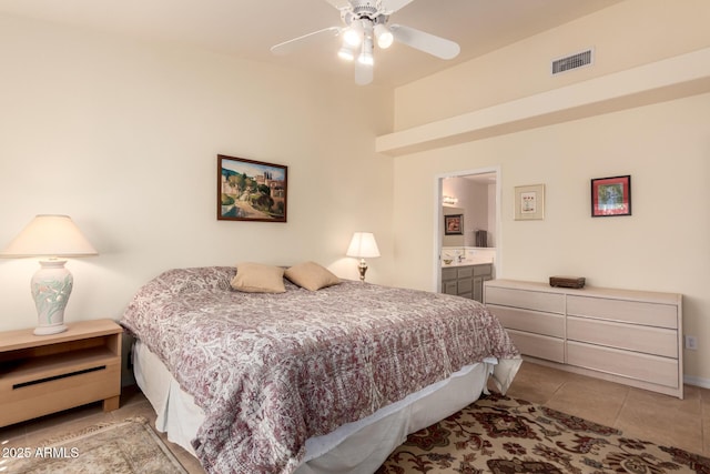 tiled bedroom featuring sink, connected bathroom, and ceiling fan