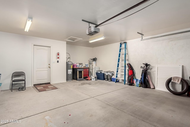 garage featuring water heater and a garage door opener