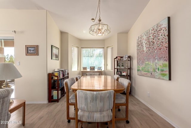 dining space featuring a chandelier and light hardwood / wood-style floors