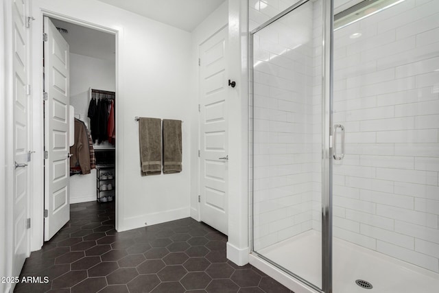 bathroom featuring tile patterned floors and a shower with door