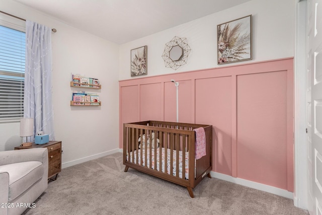 bedroom with a crib and light colored carpet