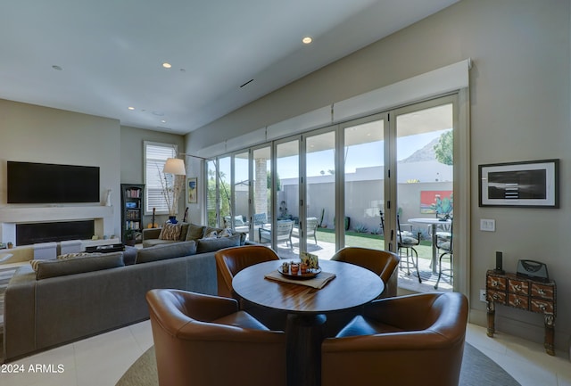 tiled dining room with plenty of natural light and a mountain view