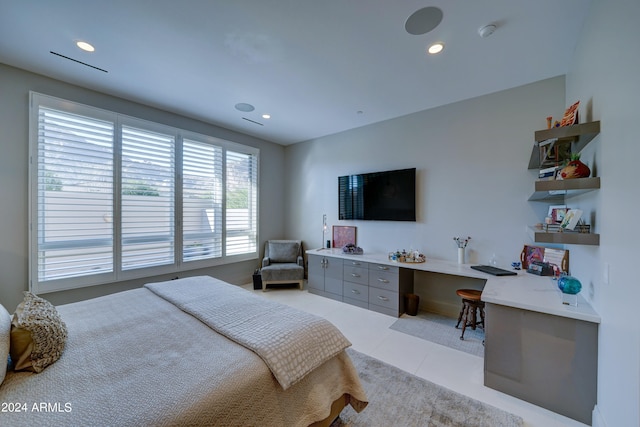 bedroom featuring light tile patterned flooring and built in desk