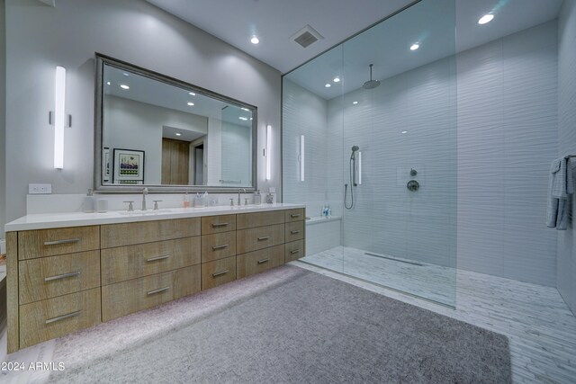 bathroom featuring vanity and tiled shower