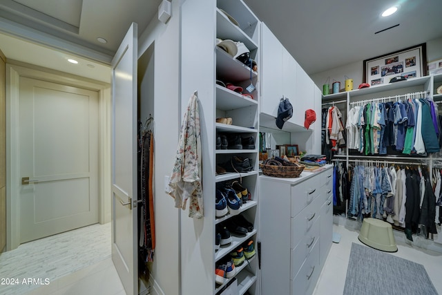 walk in closet with light tile patterned floors