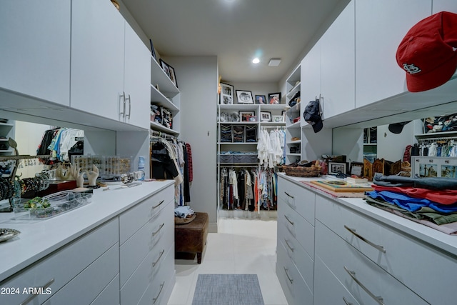 walk in closet with light tile patterned floors