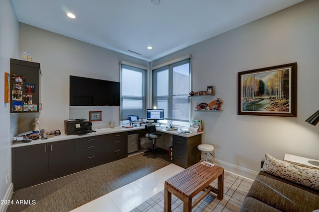 home office with light tile patterned flooring and built in desk