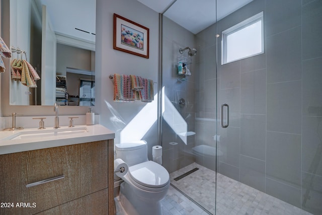 bathroom with tile patterned flooring, an enclosed shower, vanity, and toilet