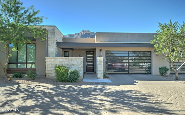 view of front facade with a mountain view and a garage