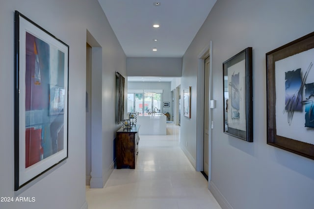 hall with light tile patterned floors