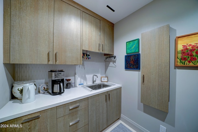 interior space with tasteful backsplash and sink