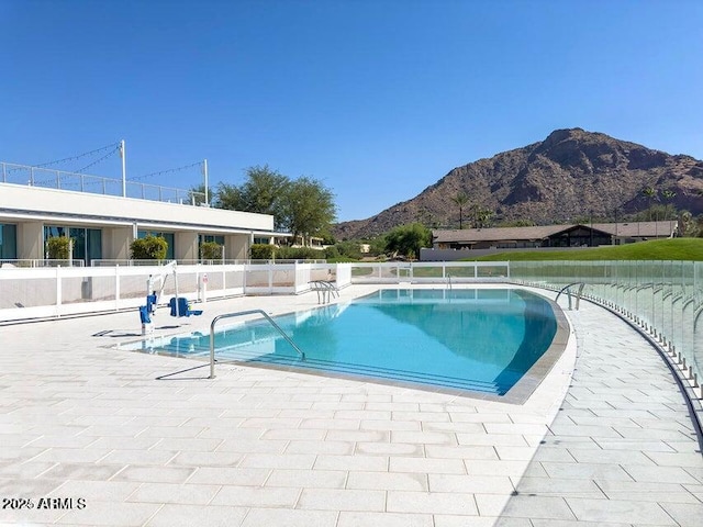 view of pool with a mountain view and a patio