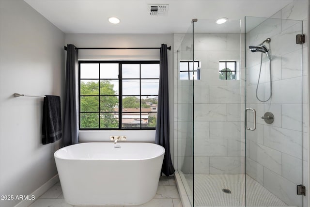 2604 N 27th St Unit 4, Phoenix, AZ 85008 - full bath featuring marble look tiles, plenty of natural light, a stall shower, baseboards, and recessed lighting